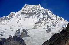 06 Gokyo 3 5 Gyachung Kang Close Up From Near Gokyo Gyachung Kang (7952m) shines bright white in the late morning sun from the terminal moraine of the Nguzumpa Glacier from beyond Gokyo.